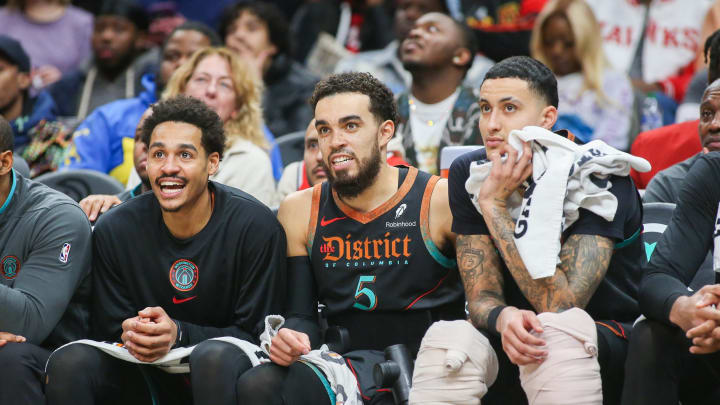 Jan 13, 2024; Atlanta, Georgia, USA; Washington Wizards guard Jordan Poole (13) and guard Tyus Jones (5) and forward Kyle Kuzma (33) watch a game against the Atlanta Hawks in the second half at State Farm Arena. Mandatory Credit: Brett Davis-USA TODAY Sports