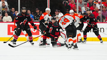 Nov 5, 2024; Raleigh, North Carolina, USA;  Philadelphia Flyers right wing Matvei Michkov (39) takes a shot past Carolina Hurricanes center Jack Drury (18) during the first period at Lenovo Center. 