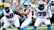 Oct 5, 2025; Charlotte, North Carolina, USA; Carolina Panthers quarterback Bryce Young (9) with the ball as guard Damien Lewis (68) and offensive tackle Ikem Ekwonu (79) block in the second quarter at Bank of America Stadium. 