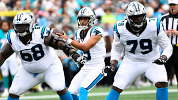 Oct 5, 2025; Charlotte, North Carolina, USA; Carolina Panthers quarterback Bryce Young (9) with the ball as guard Damien Lewis (68) and offensive tackle Ikem Ekwonu (79) block in the second quarter at Bank of America Stadium. 