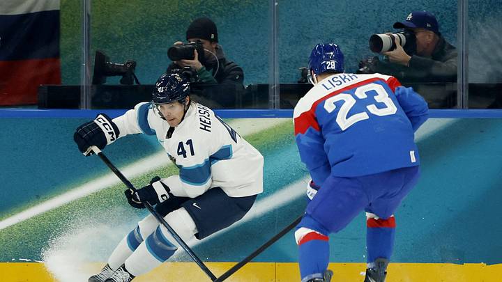 Feb 11, 2026; Milan, Italy; Miro Heiskanen of Finland in action with Adam Liska of Slovakia in men's ice hockey group B play during the Milano Cortina 2026 Olympic Winter Games at Milano Santagiulia Ice Hockey Arena. Mandatory Credit: Geoff Burke-Imagn Images
