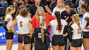 Nebraska volleyball head coach Dani Busboom Kelly and members of the coaching staff huddle on the sideline during the AVCA First Serve vs. Pittsburgh.