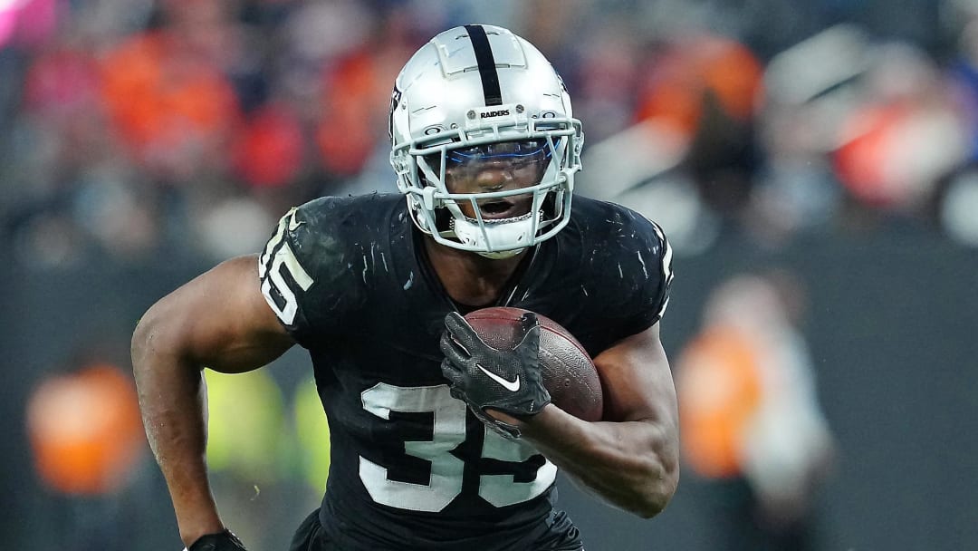 Jan 7, 2024; Paradise, Nevada, USA; Las Vegas Raiders running back Zamir White (35) gains yardage against the Denver Broncos during the fourth quarter at Allegiant Stadium. Mandatory Credit: Stephen R. Sylvanie-USA TODAY Sports