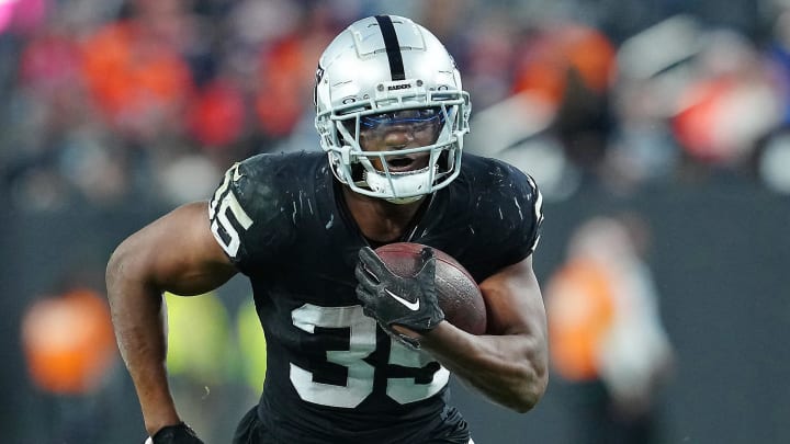 Jan 7, 2024; Paradise, Nevada, USA; Las Vegas Raiders running back Zamir White (35) gains yardage against the Denver Broncos during the fourth quarter at Allegiant Stadium. Mandatory Credit: Stephen R. Sylvanie-USA TODAY Sports