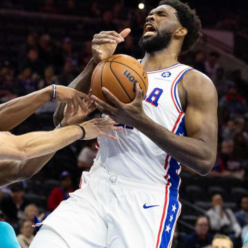 Oct 12, 2022; Philadelphia, Pennsylvania, USA; Philadelphia 76ers center Joel Embiid (21) looses control of the ball while driving against Charlotte Hornets forward Gordon Hayward (20) during the second quarter at Wells Fargo Center. Mandatory Credit: Bill Streicher-USA TODAY Sports