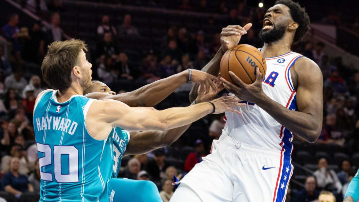 Oct 12, 2022; Philadelphia, Pennsylvania, USA; Philadelphia 76ers center Joel Embiid (21) looses control of the ball while driving against Charlotte Hornets forward Gordon Hayward (20) during the second quarter at Wells Fargo Center. Mandatory Credit: Bill Streicher-USA TODAY Sports