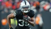 Jan 7, 2024; Paradise, Nevada, USA; Las Vegas Raiders running back Zamir White (35) gains yardage against the Denver Broncos during the fourth quarter at Allegiant Stadium. Mandatory Credit: Stephen R. Sylvanie-USA TODAY Sports