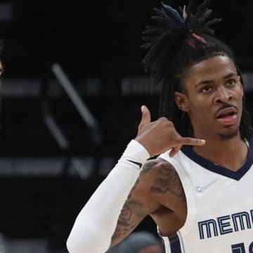 Nov 1, 2021; Memphis, Tennessee, USA; Memphis Grizzles guard Ja Morant (12) makes a phone gesture after a made basket during the second half against the Denver Nuggets  at FedExForum. Mandatory Credit: Petre Thomas-USA TODAY Sports