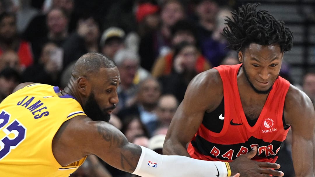 Toronto Raptors guard Immanuel Quickley steals the ball from Los Angeles Lakers forward LeBron James.