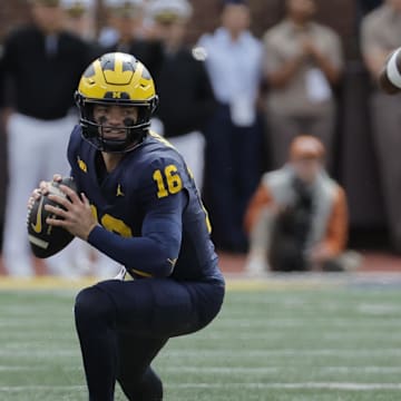 Sep 7, 2024; Ann Arbor, Michigan, USA; Michigan Wolverines quarterback Davis Warren (16) drops back to pass in the second half against the Texas Longhorns at Michigan Stadium. Mandatory Credit: Rick Osentoski-Imagn Images