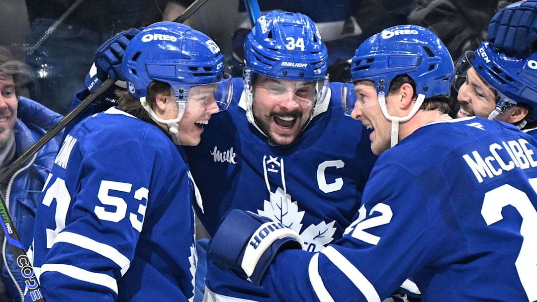 Jan 1, 2026; Toronto, Ontario, CAN;  Toronto Maple Leafs forward Auston Matthews (34) celebrates with forwards Easton Cowan (53) and Nick Robertson (89) and defensemen Jake McCabe (22) and Troy Stecher (28) after scoring his third goal of the game against the Winnipeg Jets in the third period at Scotiabank Arena. Mandatory Credit: Dan Hamilton-Imagn Images