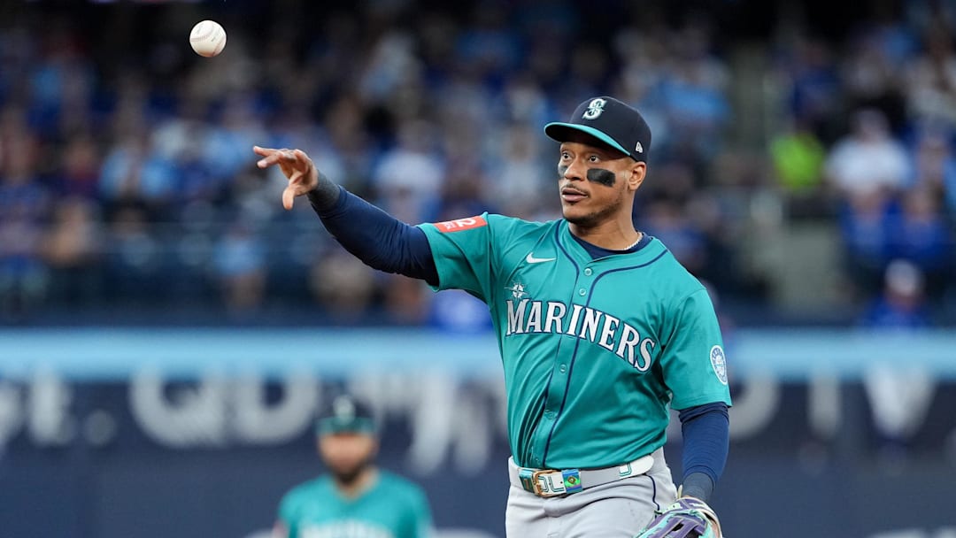 Oct 13, 2025; Toronto, Ontario, CAN; Seattle Mariners infielder Jorge Polanco (7) throws to first base for the first out in the third inning against the Toronto Blue Jays during game two of the ALCS round for the 2025 MLB playoffs at Rogers Centre. Mandatory Credit: Nick Turchiaro-Imagn Images