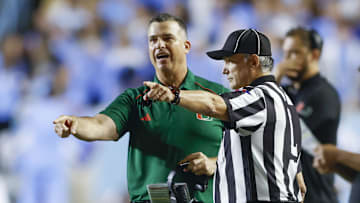 Oct 14, 2023; Chapel Hill, North Carolina, USA; Miami Hurricanes head coach Mario Cristobal argues with an official in the first half against the North Carolina Tar Heels at Kenan Memorial Stadium. Mandatory Credit: Nell Redmond-Imagn Images