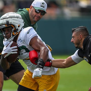 Gren Bay Packers running back MarShawn Lloyd (32) runs through a ball-security drill during training camp.