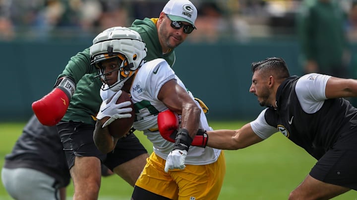 Gren Bay Packers running back MarShawn Lloyd (32) runs through a ball-security drill during training camp.