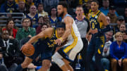 Dec 14, 2022; Indianapolis, Indiana, USA; Indiana Pacers guard Andrew Nembhard (2) dribbles against Golden State Warriors guard Stephen Curry (30) in the first quarter at Gainbridge Fieldhouse. Mandatory Credit: Trevor Ruszkowski-USA TODAY Sports