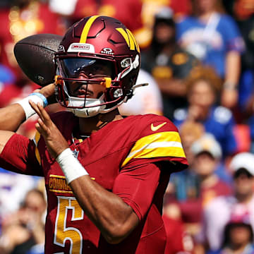 Sep 15, 2024; Landover, Maryland, USA; Washington Commanders quarterback Jayden Daniels (5) throws a pass during the first quarter against the New York Giants at Commanders Field. Mandatory Credit: Peter Casey-Imagn Images