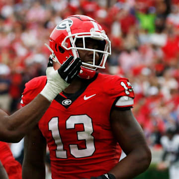 Georgia defensive lineman Mykel Williams (13) celebrates with Georgia linebacker Jamon Dumas-Johnson (10) after sacking South Carolina quarterback Spencer Rattler (7) during the second half of a NCAA college football game against South Carolina in Athens, Ga., on Saturday, Sept. 16, 2023. Georgia won 24-14.