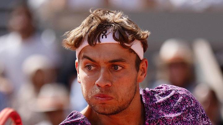 Flavio Cobolli returns a shot during a match