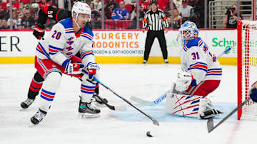 Apr 12, 2025; Raleigh, North Carolina, USA;  New York Rangers left wing Chris Kreider (20) picks up the puck in front of goaltender Igor Shesterkin (31) against the Carolina Hurricanes during the third period at Lenovo Center. Mandatory Credit: James Guillory-Imagn Images