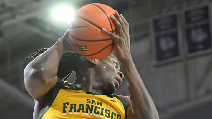 Jan 25, 2024; Spokane, Washington, USA; San Francisco Dons forward Jonathan Mogbo (10) rebounds the ball 
against the Gonzaga Bulldogs in the first half at McCarthey Athletic Center. Mandatory Credit: James Snook-Imagn Images