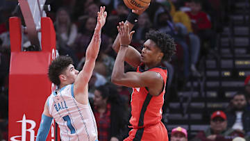 Nov 1, 2023; Houston, Texas, USA; Houston Rockets guard Jalen Green (4) passes the ball as Charlotte Hornets guard LaMelo Ball (1) defends during the game at Toyota Center. Mandatory Credit: Troy Taormina-Imagn Images