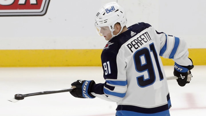 Feb 6, 2024; Pittsburgh, Pennsylvania, USA;  Winnipeg Jets center Cole Perfetti (91) juggles a puck to warm up before the game against the Pittsburgh Penguins at PPG Paints Arena. Mandatory Credit: Charles LeClaire-USA TODAY Sports