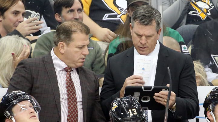 Oct 8, 2019; Pittsburgh, PA, USA;  Pittsburgh Penguins assistant coach Mark Recchi (left) and head coach Mike Sullivan (right) look at a replay on a tablet device against the Winnipeg Jets during the second period at PPG PAINTS Arena. Mandatory Credit: Charles LeClaire-USA TODAY Sports