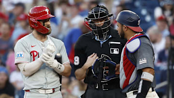 Sep 28, 2024; Washington, District of Columbia, USA; Philadelphia Phillies first base Bryce Harper (3) exchanges words with Washington Nationals catcher Keibert Ruiz (20) during the eighth inning at Nationals Park. Mandatory Credit: Geoff Burke-Imagn Images