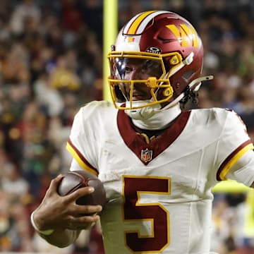 Nov 2, 2025; Landover, Maryland, USA; Washington Commanders quarterback Jayden Daniels (5) runs the ball against the Seattle Seahawks during the first half at Northwest Stadium. Mandatory Credit: Amber Searls-Imagn Images