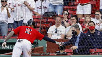 Boston Red Sox shortstop Xander Bogaerts (2) slaps hands with Red Sox owner John Henry after hitting a three-run home run against the Los Angeles Angels during the fifth inning at Fenway Park. 