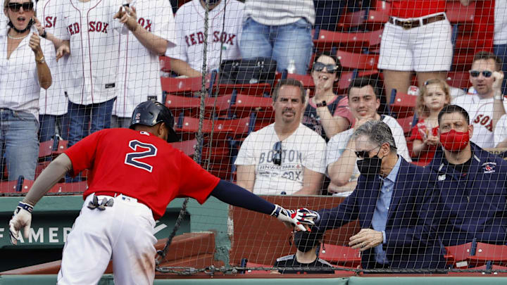 Boston Red Sox shortstop Xander Bogaerts (2) slaps hands with Red Sox owner John Henry after hitting a three-run home run against the Los Angeles Angels during the fifth inning at Fenway Park. 