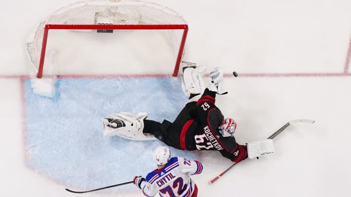 May 9, 2024; Raleigh, North Carolina, USA; Carolina Hurricanes goaltender Pyotr Kochetkov (52) makes a save against the New York Rangers during the third period in game three of the second round of the 2024 Stanley Cup Playoffs at PNC Arena. Mandatory Credit: James Guillory-USA TODAY Sports