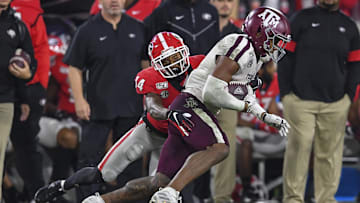 Nov 23, 2019; Athens, GA, USA; Texas A&M Aggies wide receiver Jhamon Ausbon (2) is tackled by Georgia Bulldogs defensive back DJ Daniel (14) during the second half at Sanford Stadium. Mandatory Credit: Dale Zanine-Imagn Images