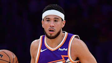 Dec 1, 2025; Los Angeles, California, USA; Phoenix Suns guard Devin Booker (1) moves the ball up court against the Los Angeles Lakers during the first half at Crypto.com Arena. Mandatory Credit: Gary A. Vasquez-Imagn Images