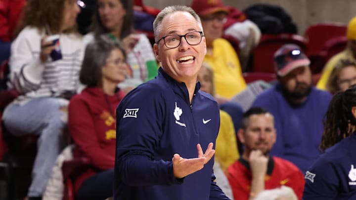 Jan 11, 2026; Ames, Iowa, USA; West Virginia Mountaineers head coach Mark Kellogg watches his team play the Iowa State Cyclones during the first half at James H. Hilton Coliseum. Mandatory Credit: Reese Strickland-Imagn Images