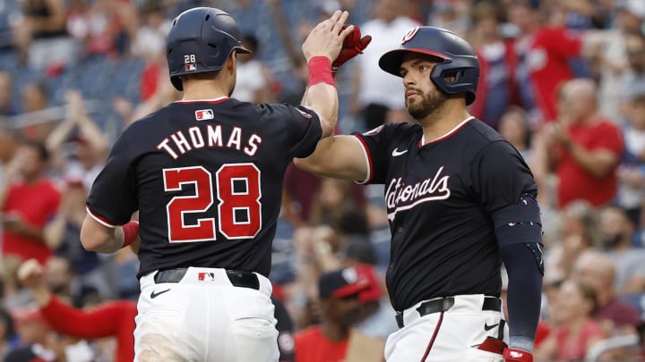 Washington Nationals outfielder Lane Thomas (28) celebrates with Nationals first baseman Juan Yepez (18) after scoring a run against the San Diego Padres during the first inning at Nationals Park