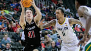 Mar 14, 2024; Kansas City, MO, USA; Cincinnati Bearcats guard Simas Lukosius (41) drives to the basket around Baylor Bears forward Jalen Bridges (11) during the second half at T-Mobile Center. Mandatory Credit: William Purnell-Imagn Images