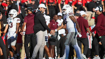 Oct 12, 2024; Athens, Georgia, USA; Mississippi State Bulldogs head coach Jeff Lebby celebrates with quarterback Michael Van Buren Jr. (0) after a touchdown against the Georgia Bulldogs in the second quarter at Sanford Stadium. Mandatory Credit: Brett Davis-Imagn Images