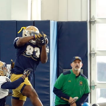 Notre Dame wide receiver Jayden Thomas makes a catch over Christian Gray during a drill in practice Tuesday, Dec. 19, 2023, at the Irish Athletics Center in South Bend.