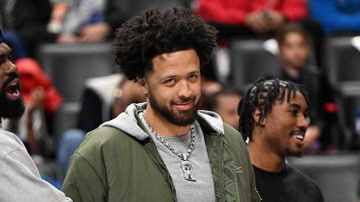 Cunningham smiles toward the camera on the bench at Little Caesars Arena Cunningham smiles toward the camera on the bench at Little Caesars Arena