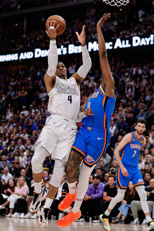 Denver Nuggets guard Russell Westbrook drives to the net against Oklahoma City Thunder forward Jalen Williams.
