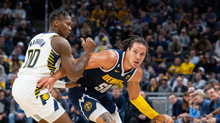 Nov 9, 2022; Indianapolis, Indiana, USA; Denver Nuggets forward Aaron Gordon (50) dribbles the ball while Indiana Pacers guard Bennedict Mathurin (00) defends in the second half at Gainbridge Fieldhouse. Mandatory Credit: Trevor Ruszkowski-Imagn Images