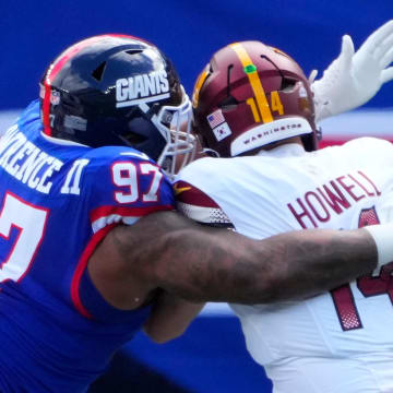Oct 22, 2023; East Rutherford, New Jersey, USA; New York Giants defensive tackle Dexter Lawrence II (97) sacks Washington Commanders quarterback Sam Howell (14) in the first half  at MetLife Stadium. Mandatory Credit: Robert Deutsch-USA TODAY Sports
