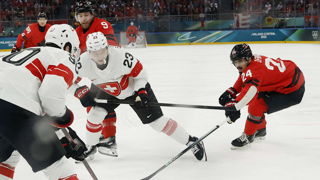 Feb 13, 2026; Milan, Italy; Seth Jarvis of Canada in action with Philipp Kurashev and Roman Josi of Switzerland in men's ice hockey group A play during the Milano Cortina 2026 Olympic Winter Games at Milano Santagiulia Ice Hockey Arena. Mandatory Credit: Geoff Burke-Imagn Images