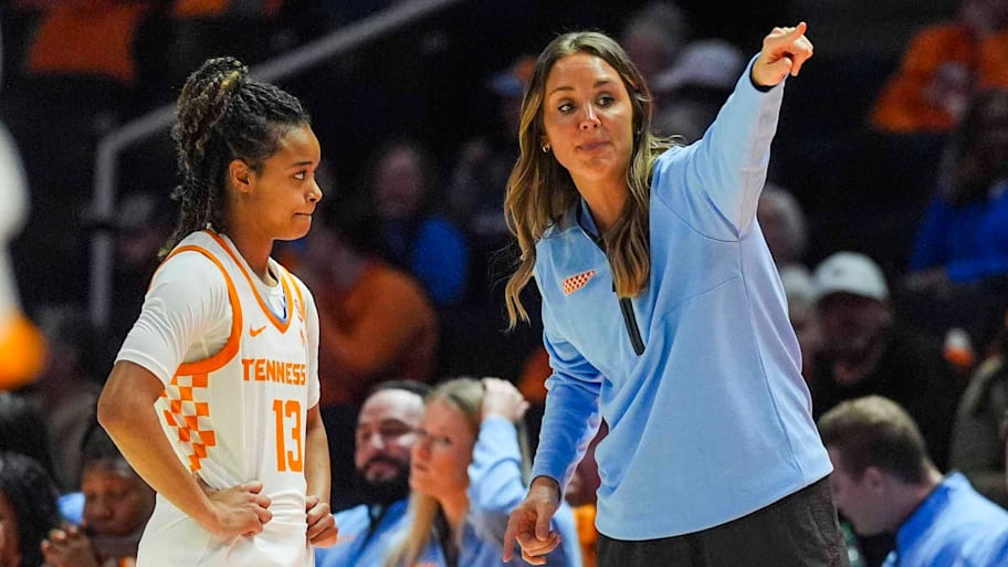Tennessee coach Kim Caldwell talks to Tennessee guard Mia Pauldo (13) on the sidelines