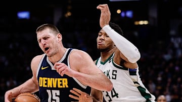 Jan 29, 2024; Denver, Colorado, USA; Denver Nuggets center Nikola Jokic (15) controls the ball against Milwaukee Bucks forward Giannis Antetokounmpo (34) in the third quarter at Ball Arena. Mandatory Credit: Isaiah J. Downing-Imagn Images