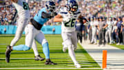 Seattle Seahawks running back Zach Charbonnet (26) scores a touchdown past Tennessee Titans linebacker Jihad Ward (53) during the third quarter at Nissan Stadium in Nashville, Tenn., Sunday, Nov. 23, 2025.