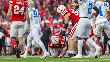 Nebraska quarterback Dylan Raiola is helped up after being sacked by UCLA early in the fourth quarter. He left the game after being injured during the Huskers' next offensive series.