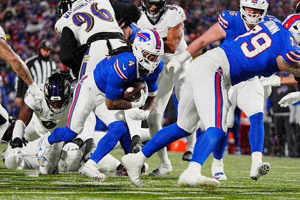 Buffalo Bills running back James Cook, carrying the ball against the Baltimore Ravens at Highmark Stadium.